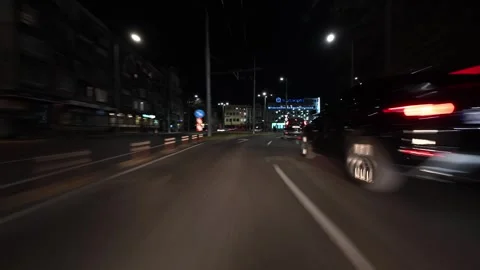 Night city drive hyperlapse with motion blur and light trails, filmed from a Stock Footage 324705021