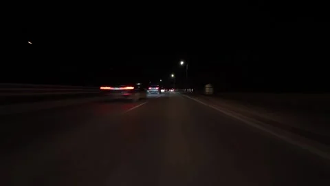 Night city drive hyperlapse with motion blur and light trails, filmed from a Stock Footage 324705597