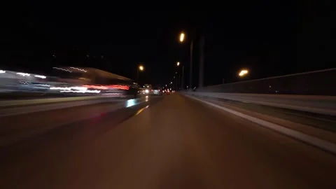 Night city drive hyperlapse with motion blur and light trails, filmed from a Stock Footage 324789377