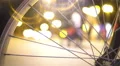 Night city life, defocused people walking street, view through bicycle wheel 4k or 4k+ Resolution