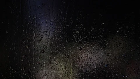 Night city lights behind wet window. Stock Footage 100577672