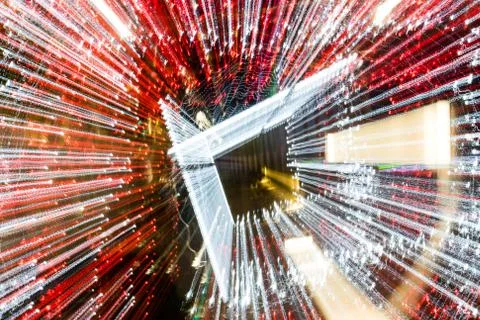 Night city lights diffused with camera motion and zoom out on long exposure. Foto stock