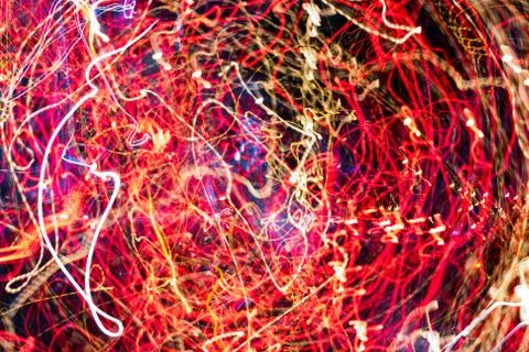 Night city lights diffused with camera motion and zoom out on long exposure. Stock Photos