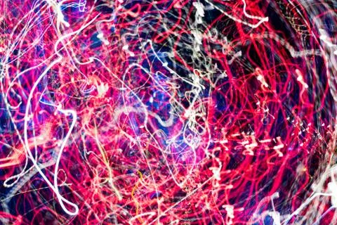 Night city lights diffused with camera motion and zoom out on long exposure. Stock Photos