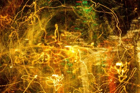 Night city lights diffused with camera motion and zoom out on long exposure. Stock Photos