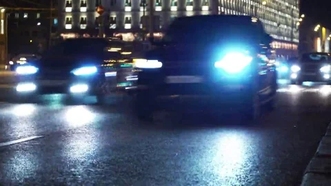Night city lights. Reflection of car headlights on the road. Traffic jam closeup Stock Footage 69099751
