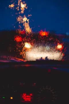 Night city road through windshield cars abstract background water drop on the Stock Photos