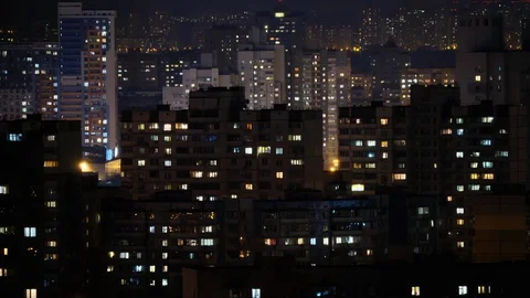 Night city. Time lapse. The light in the windows of houses and residential Stock Footage 106823922