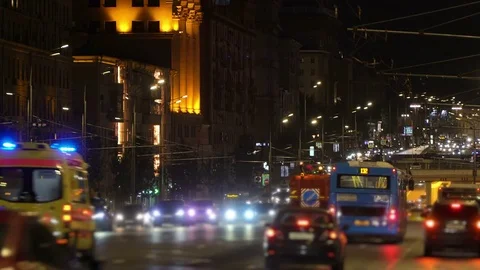 Night City traffic. Ambulance with emergency lights to the rescue. Night City Stock Footage