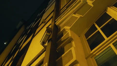 Night city view with a CCTV security camera on the wall Stock Footage 272273354