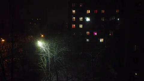 Night city in winter view from the window. It is snowing and light Stock Footage 126311169