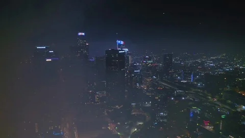 Night cityscape with distant fireworks flashes seen on the horizon. Los Angeles Stock-Footage 129869444