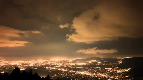 Night Cityscape with Dramatic Cloud Movement Above the Skyline Stock Footage 336489081