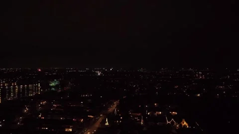 Night Cityscape Drone Descent With Distant Fireworks Display Stock Footage 337152587