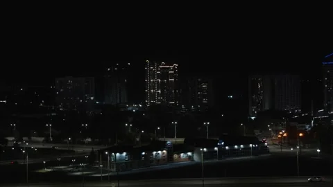 A night cityscape featuring several high-rise residential buildings and illum Stock Footage 345019935