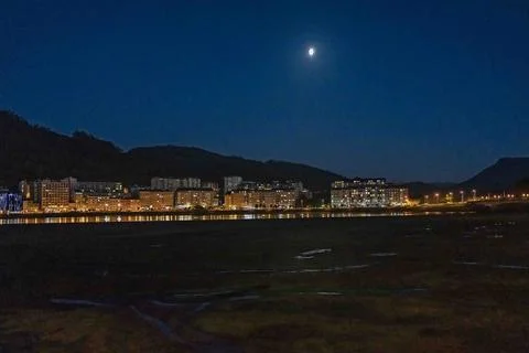 Night Cityscape with Moon Reflection Stock Photos