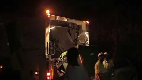 Night cleaning of garbage by workers on the garbage truck. Cala Mendia. Mallorca Stock Footage 75608686