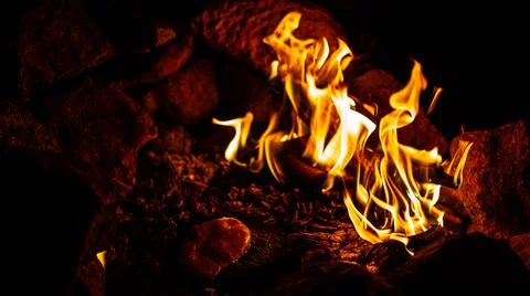 Night close up of chichen stake coocing on hot stone near fire in fireplace Stock Photos