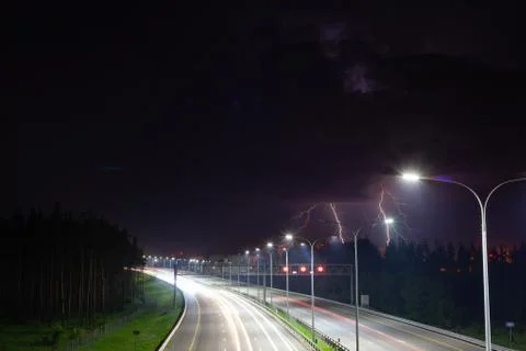 Night clouds with lightning over the night route Stock Photos