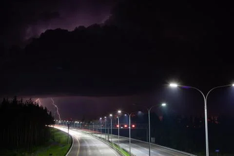 Night clouds with lightning over the night route Stock Photos