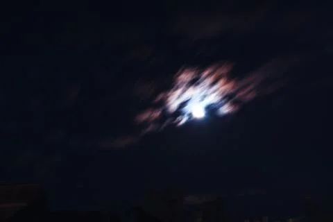 Night clouds in motion and glowing moon background Stock Photos