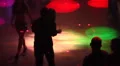 Night club scenes - silhouettes on a dance floor - 1 funky lights high angle HD Footage