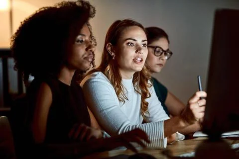 Night, computer and teamwork in office, brainstorming project or software d.. Stock Photos