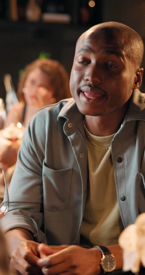 Night, couple and man with talking in restaurant for first date, connection and Stock Footage 329384864
