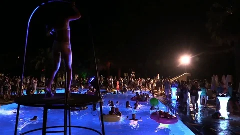 Night crowd active outdoor poolside party Stock Footage 84144788