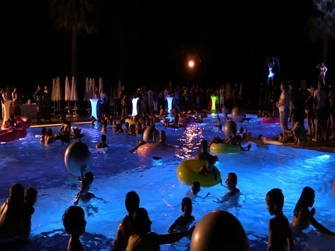 Night crowd active outdoor poolside party Stock Footage 84144825