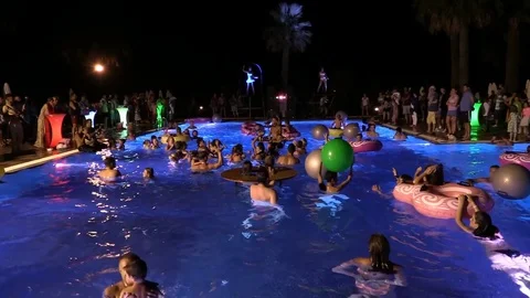 Night crowd active outdoor poolside party Stock Footage 84144829
