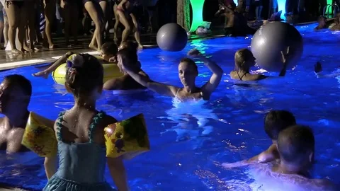 Night crowd active outdoor poolside party Stock Footage 84144831