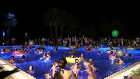 Night crowd active outdoor poolside party Stock Footage 84144839