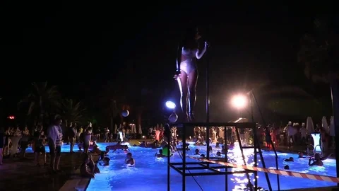 Night crowd active outdoor poolside party Stock Footage 84144851