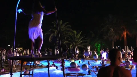 Night crowd active outdoor poolside party backstage Stock Footage 84144852