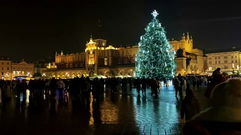 Night crowd around a huge illuminated Christmas tree at Krakow Main Market Stock Footage 326357243