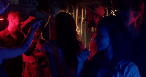 At night crowd or group of young multi-ethnic people during dancing colorful Stock Footage 115392786