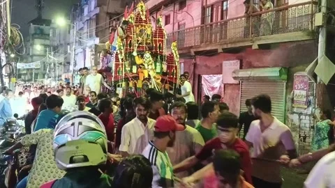 Night crowd pulling illuminated Rath Yatra chariot on city street in Howrah Stock Footage 340826078