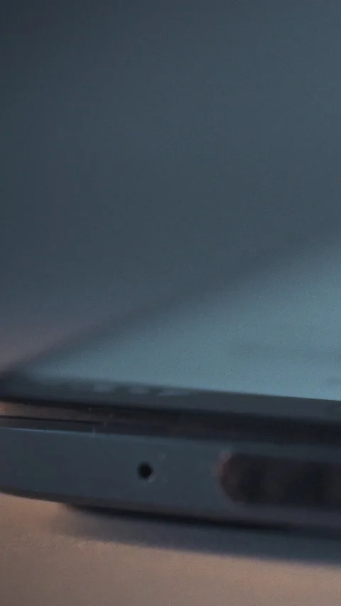 At night in darkness a smartphone screen lights up as the device activates d Stock Footage 341283819