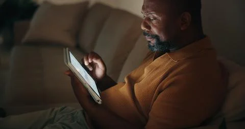 Night, data analysis or black man in home with tablet screen, forecast or b.. Stock Photos