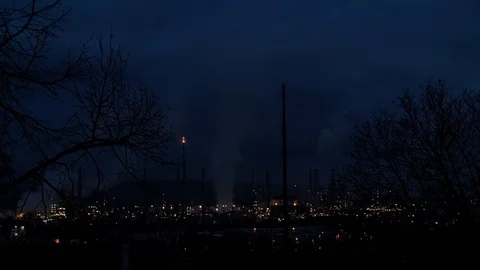 Night to dawn day time lapse of smoke from chimney of a French oil refinery  Stock Footage 99770670