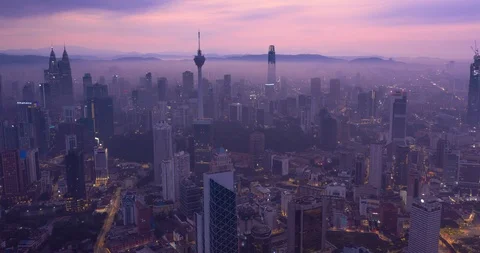 Night to day Aerial hyper lapse of Kuala Lumpur skyline covered with mist Stock Footage 119221969