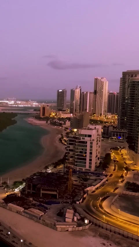 Night-to-day vertical timelapse cloudscape on Al Reem Island in Abu Dhabi Video stock 297344131
