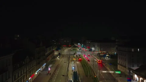 Night drone advancing along wide Warsaw street with car and tram lanes Stock Footage 339173485