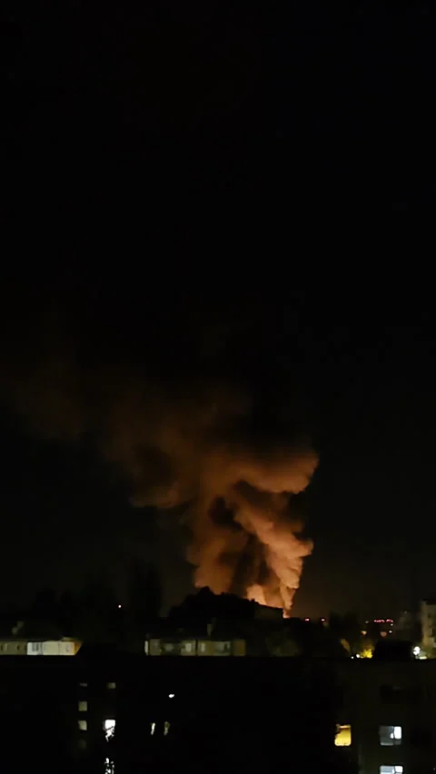 Night drone attack explosion with fire and smoke in dark sky Stockbeeldmateriaal 312415065