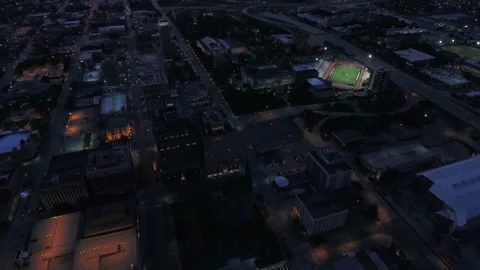 Night drone flight over downtown Omaha Nebraska featuring bright city lights 스톡 동영상 344566236