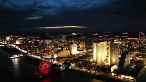 Night drone flight over downtown Atlantic City, New Jersey, city lights Stock Footage 344786196