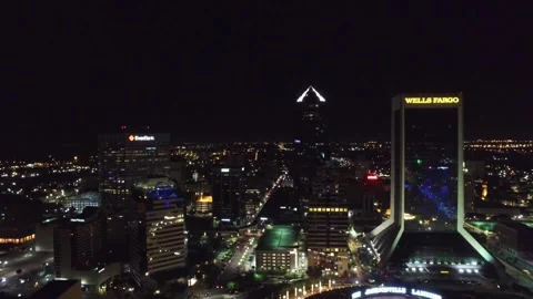 Night drone flight over downtown Jacksonville Florida glowing urban streets Stock Footage 344793330