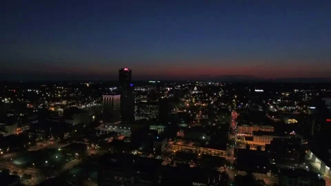 Night drone flight over downtown Little Rock Arkansas glowing urban streets Stock Footage 344796681