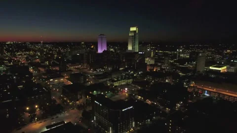 Night drone flight over Omaha Nebraska showing glowing commercial skyscrapers 스톡 동영상 344566241